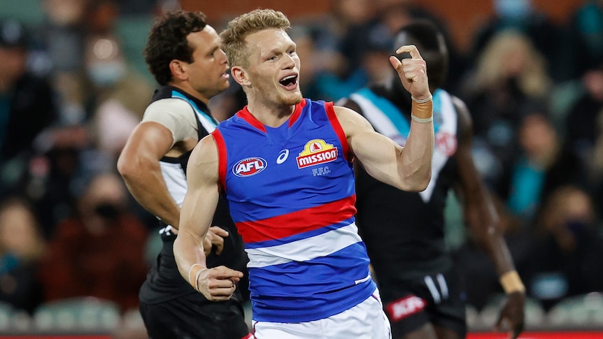 A Western Bulldogs AFL player celebrates kicking a goal.