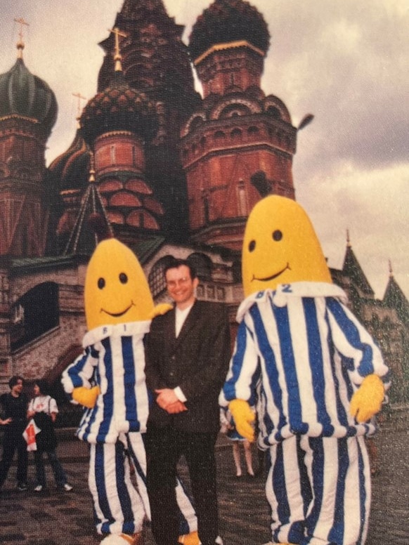 Man standing between B1 and B2 characters in Red Square in Moscow.