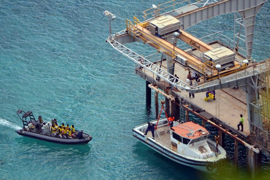 Asylum seekers approach the jetty on Christmas Island.