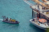 Asylum seekers approach the jetty on Christmas Island.