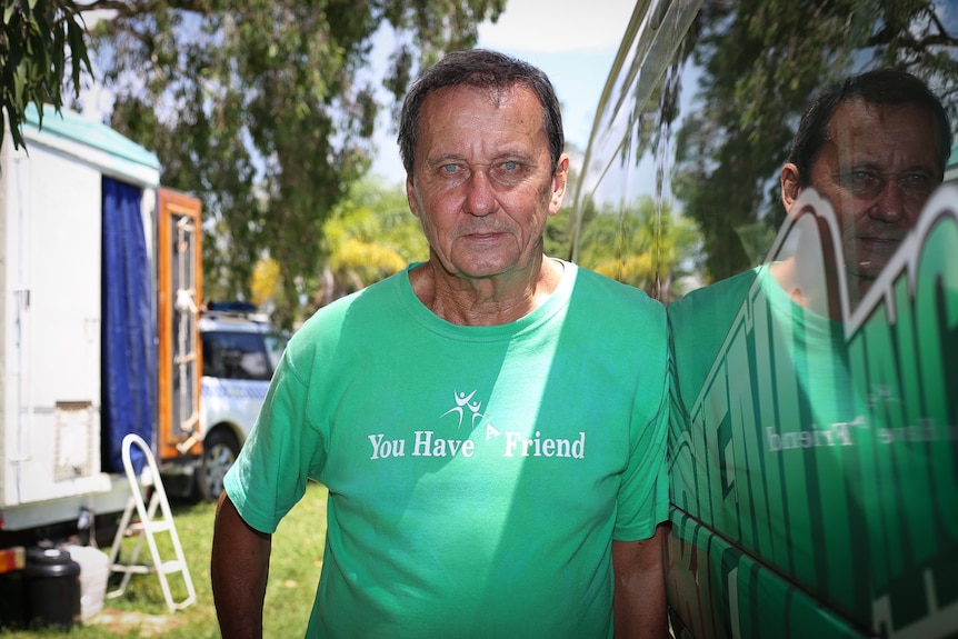 John Lee stands next to van