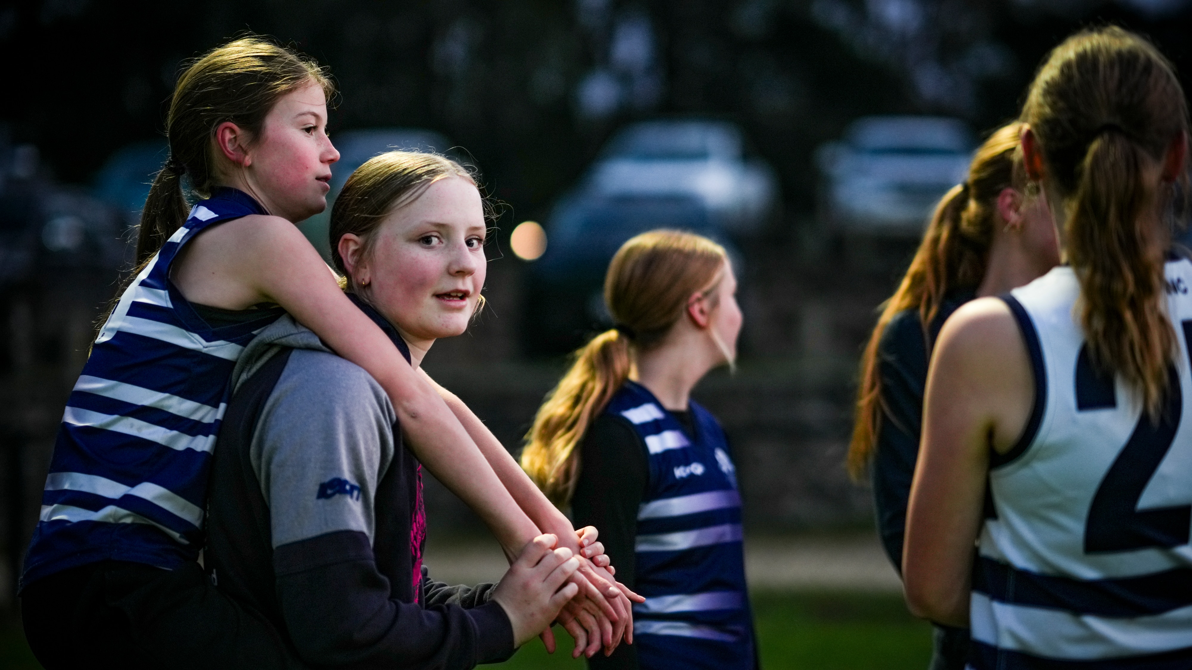 Young girls in football gear.