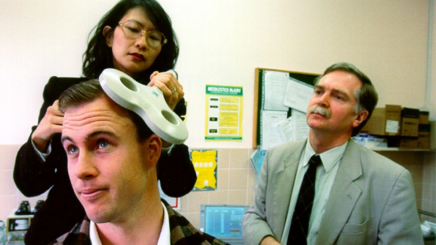 Dr Loo demonstrating transcranial magnetic stimulation (TMS) on Ben.