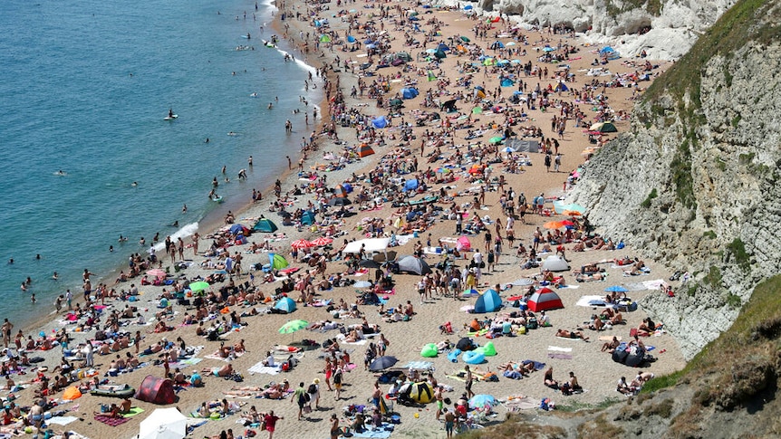 Hundreds of people packed on a beach in the UK.