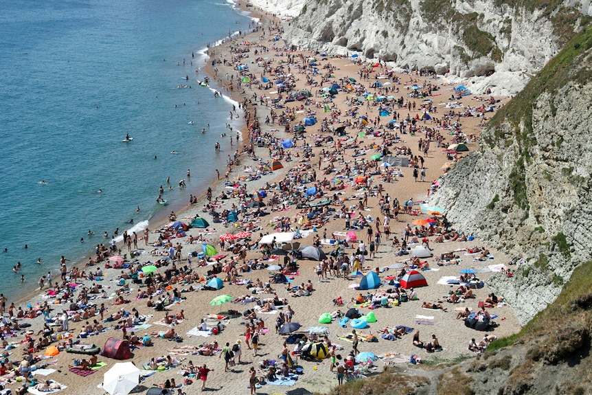 Hundreds of people packed on a beach in the UK.