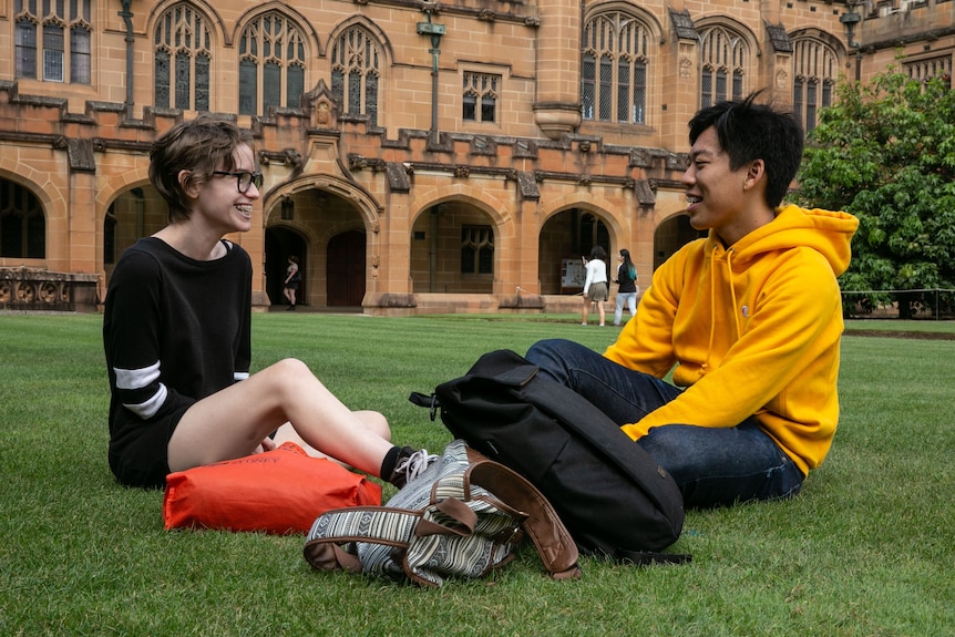 Two people sit on the lawn