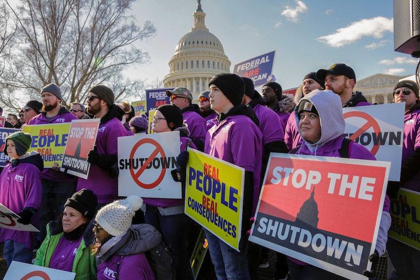workers protest against the partial US government shutdown outside the Capitol building in Washington