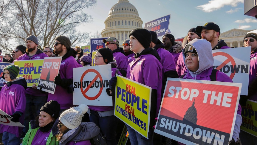 workers protest against the partial US government shutdown outside the Capitol building in Washington