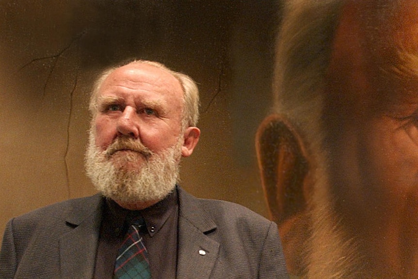 Actor Bill Hunter, a middle-aged man looks at a painting