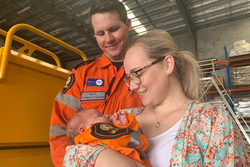SES volunteer Reece Booij with his partner Kate Booij and baby Harrison wearing an SES shirt.
