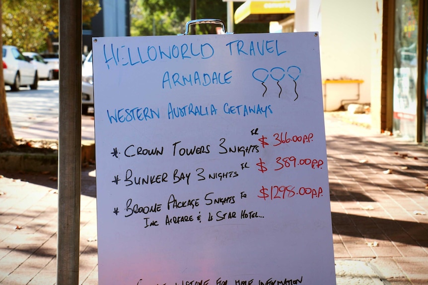 A sign outside a shop advertising WA flights