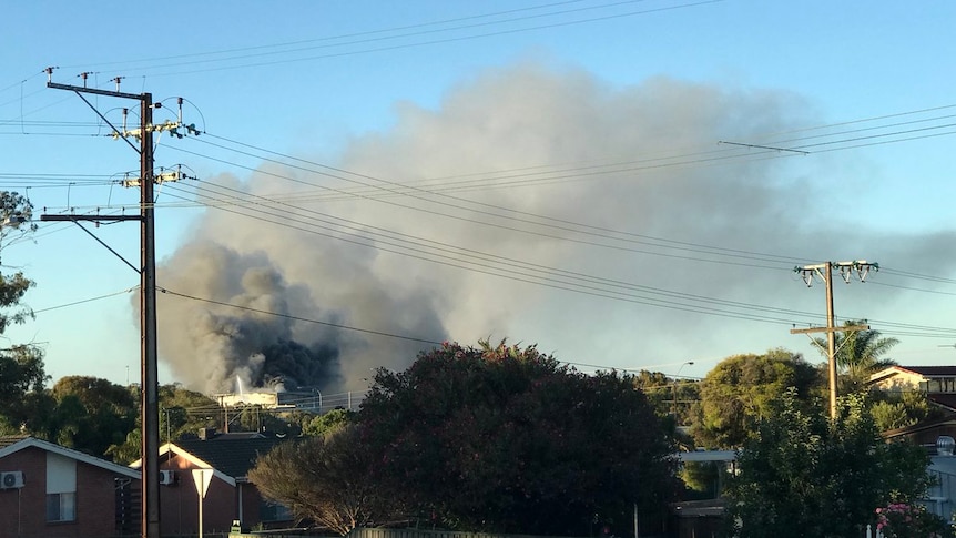 Smoke billows from a meat processing factory fire.