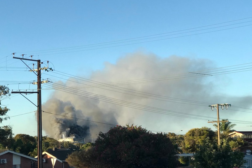 Smoke billows from a meat processing factory fire.