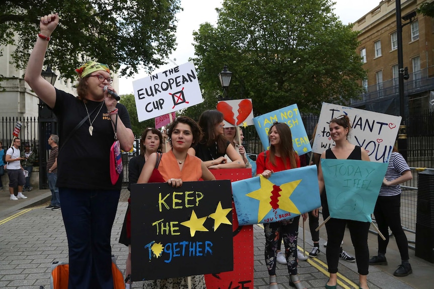 A small group of Anti-Brexit protesters protest opposite Downing Street holding posters