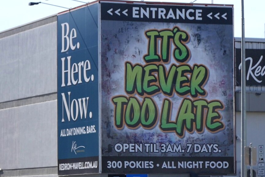 A poker machine venue sign says "it's never too late"
