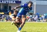 A Fijian Drua player holds the ball as he is tackled by a Crusaders opponent.