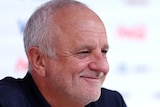 Graham Arnold smiles at a press conference