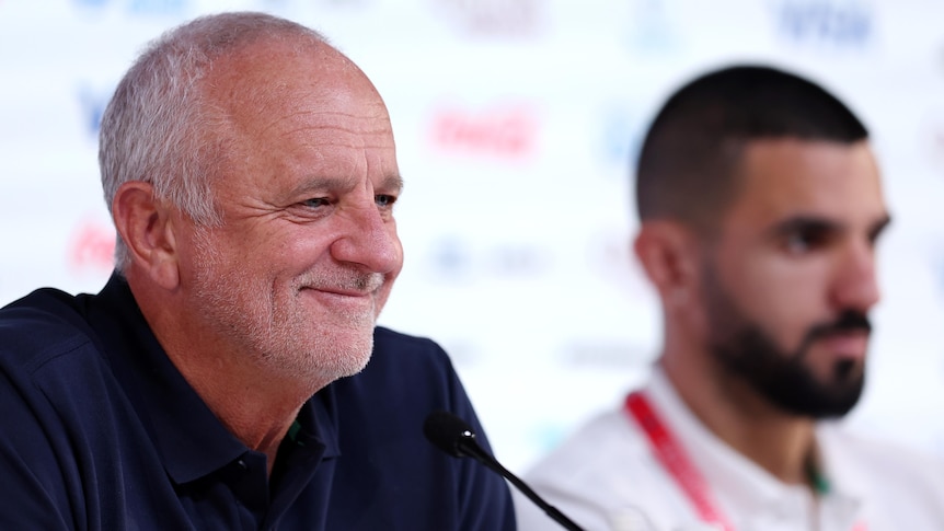 Graham Arnold smiles at a press conference