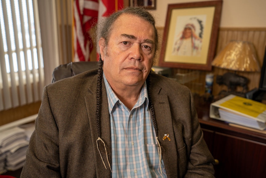 Tribal Business Council Timothy Davis sitting at his desk.