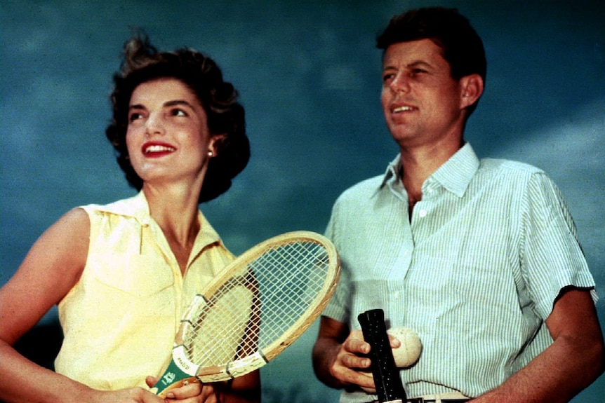 JFK and Jackie Kennedy holding tennis rackets 