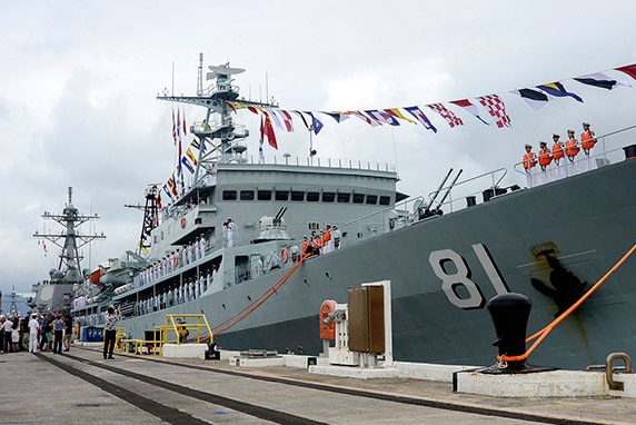 Two mid-sized naval ships are shown docked at Pearl Harbour.