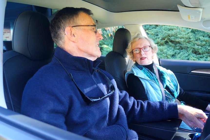 Couple talk inside car