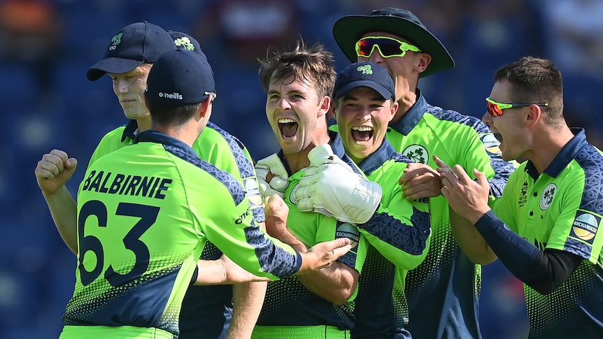 Curtis Campher and Irish teammates smile and hug at the Twenty20 World Cup.