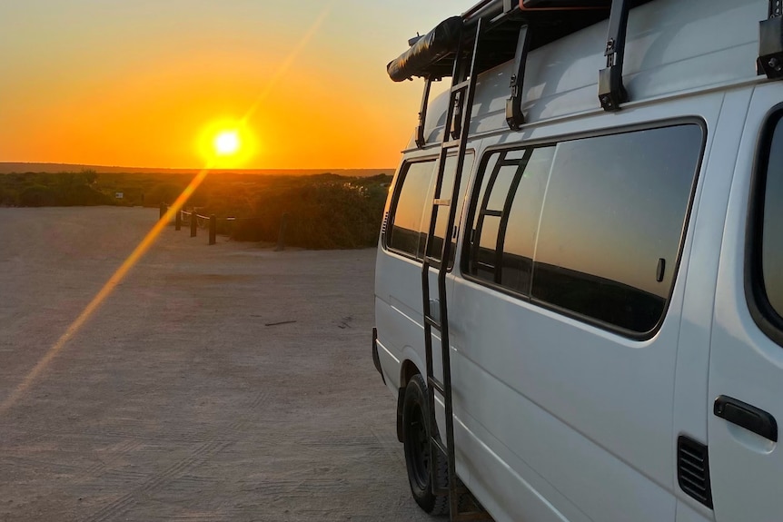 A van in front of a sunset