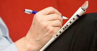 Closeup hand with pen doing crossword