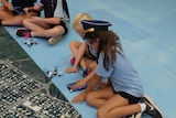 School students touching drone controller