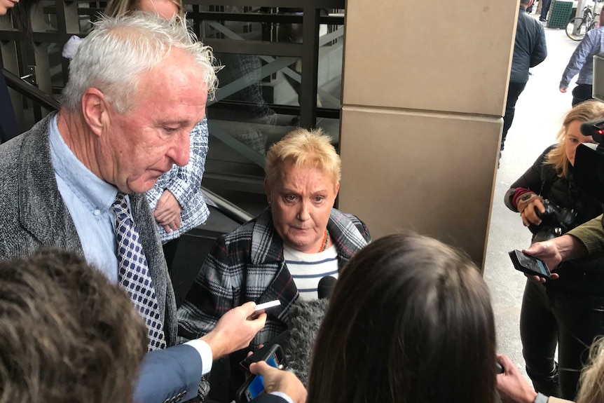 Julie Maybury wears a sad expression as she stops outside a Victorian court to speak to a crowd of journalists.