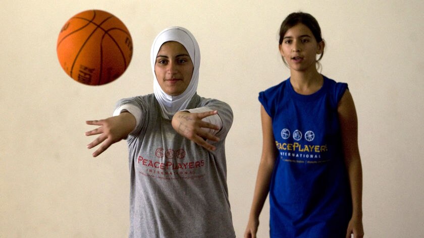 'We are peaceful'...a Palestinian (l) and Israeli girl practice.
