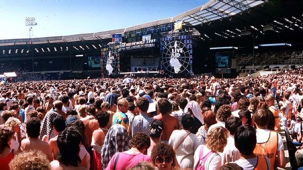 The crowds gather for the Live Aid concert at Wembley Stadium in London in 1985.