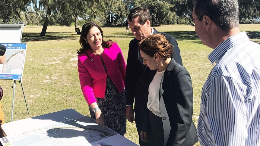 Queensland Premier Annastacia Palaszczuk, with other officials, looks at plans for The Spit on Queensland's Gold Coast.
