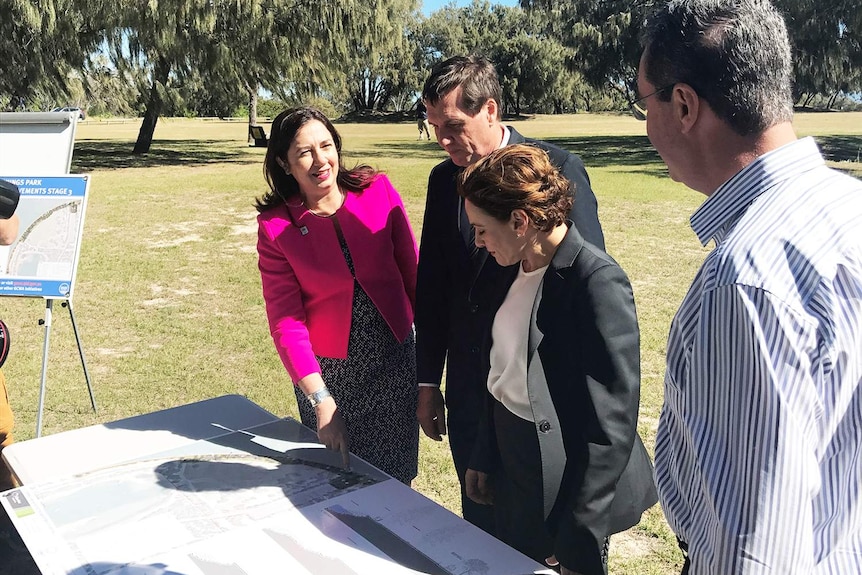 Queensland Premier Annastacia Palaszczuk, with other officials, looks at plans for The Spit on Queensland's Gold Coast.