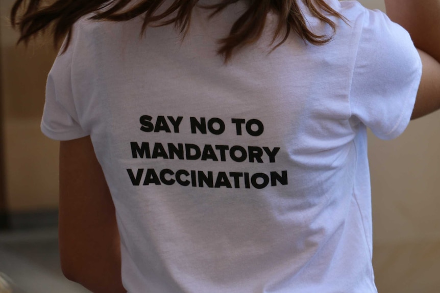 An anti-lockdown protester in Perth wears a shirt with "SAY NO TO MANDATORY VACCINATION" on the back.