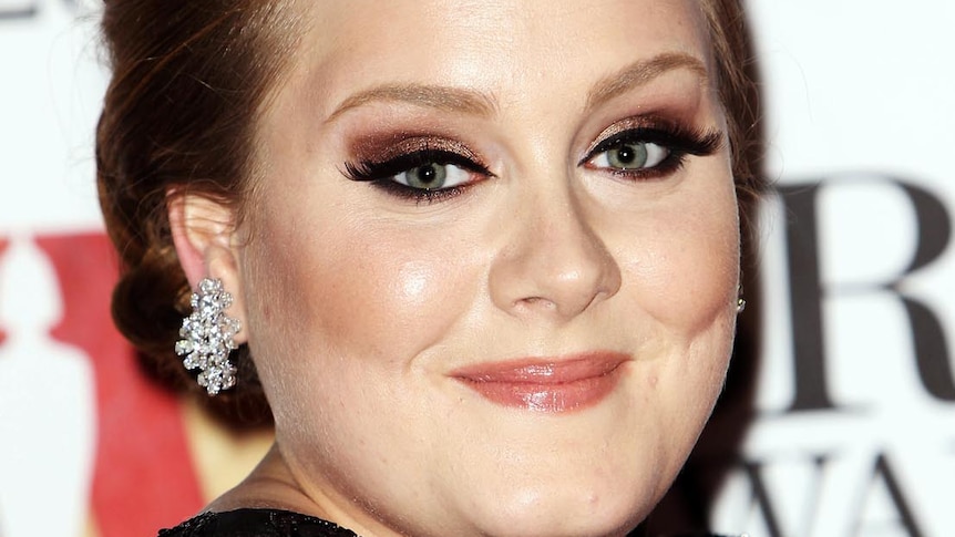 Adele stops for photos on the red carpet