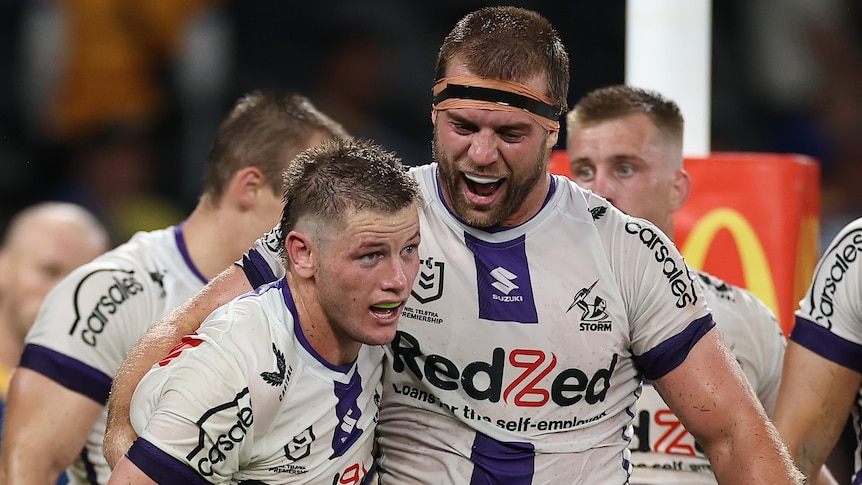 Two Melbourne Storm NRL players embrace as they celebrate a try against Parramatta.