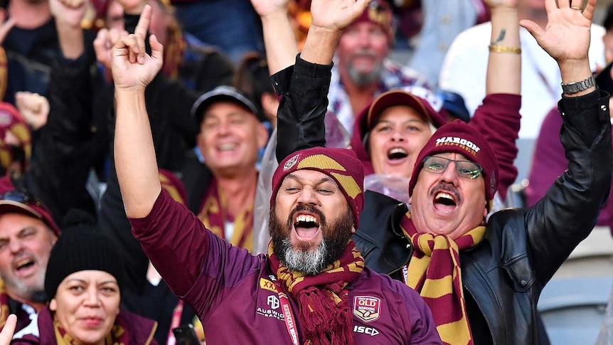 Football fans cheering in stadium seating