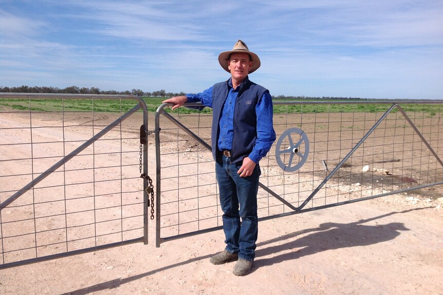 Greg Rummery standing in front of a fence.