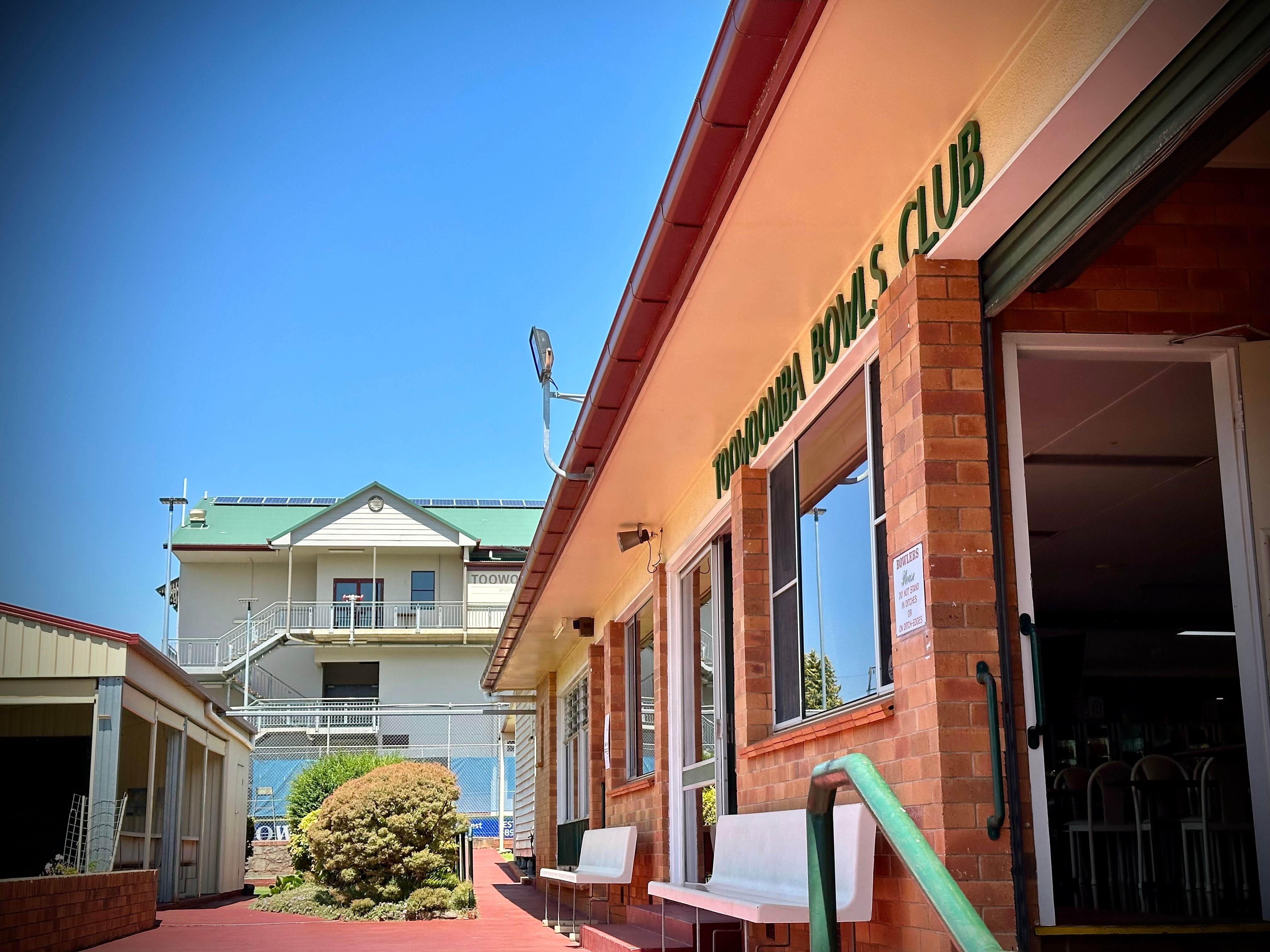 a bowls club in the foreground and stadium in the background