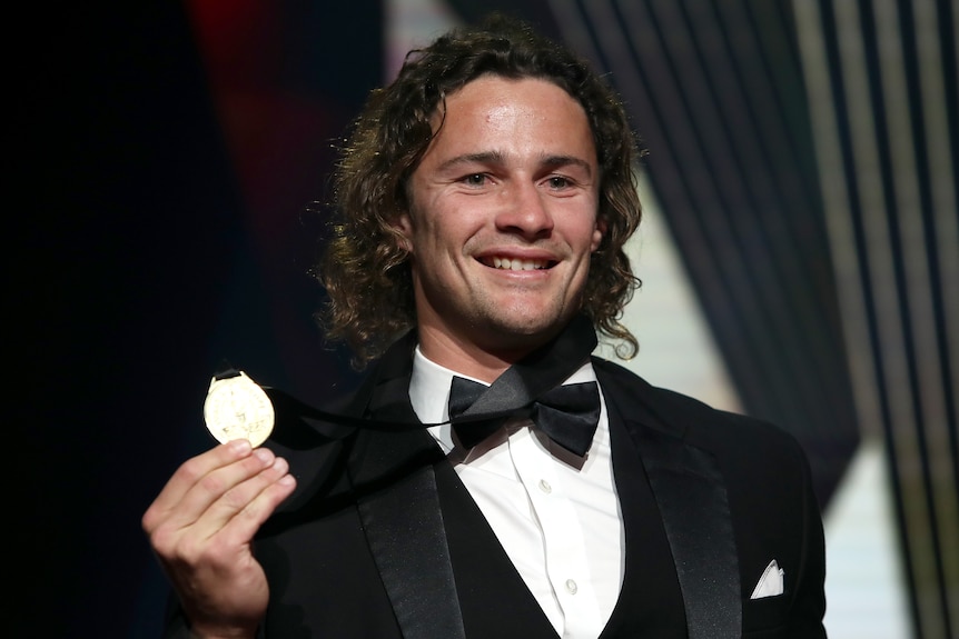 Nicho Hynes holds up the Dally M