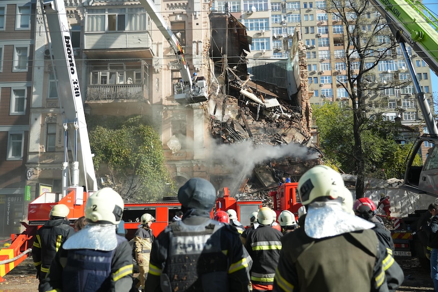 Firefighters sift through the rubble of a destroyed building in Kyiv.