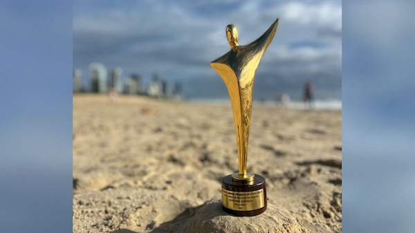 AACTA Award statue on a beach.