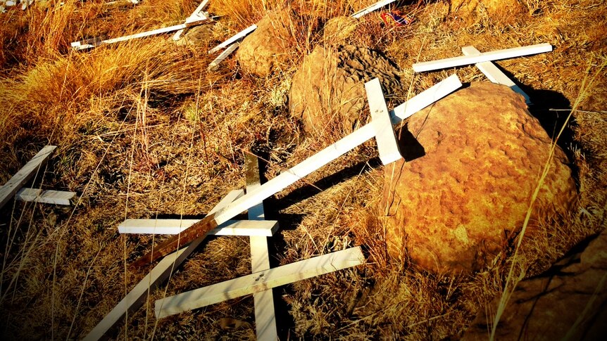 Crucifixes are scattered on the ground at the scene of the Marikana mine massacre
