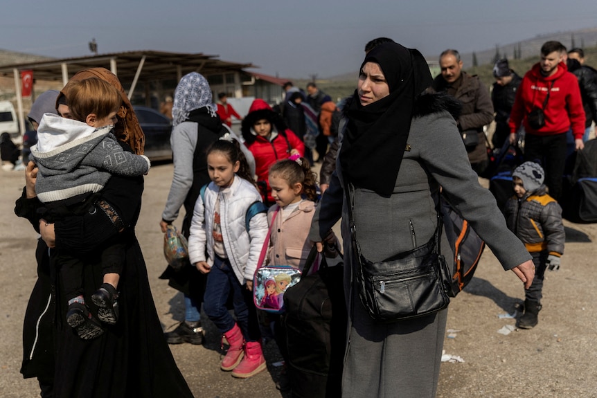 Syrians queue to enter the Cilvegozu Border Gate in the aftermath of the deadly earthquake.