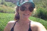 Facebook photo of Holly Winta Brown wearing a cap and sunglasses.