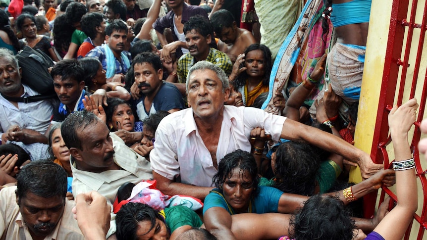 Indian devotees gather after a stampede at a religious festival in Godavari