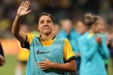 Australia's Sam Kerr waves up at the crowd in the stands after a Matildas game. 
