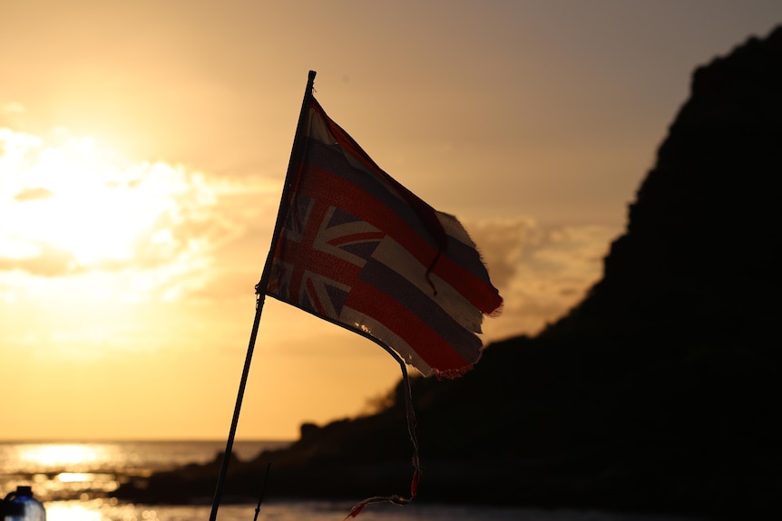 A Hawaiian flag flies upside down.